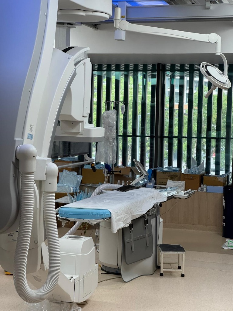 Advanced catheterization laboratory equipment with robotic C-arm and surgical lighting at Yashoda Medicity